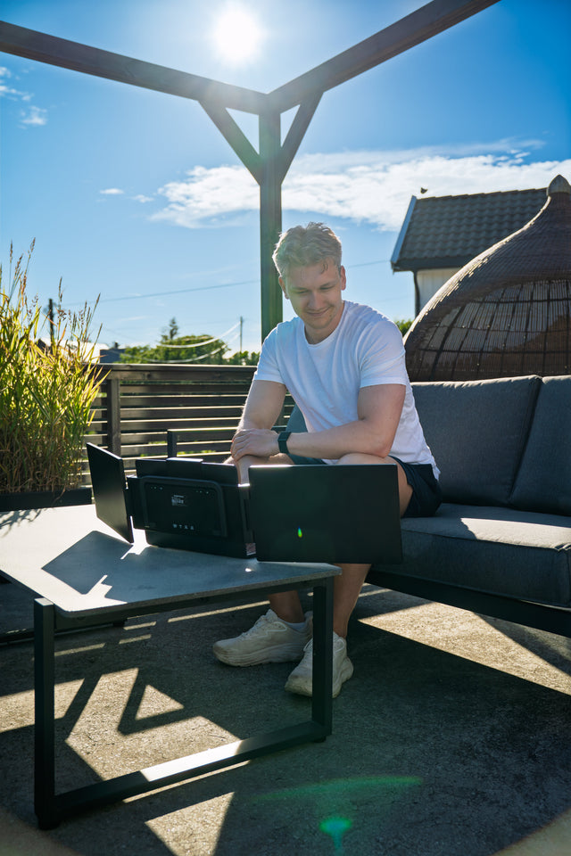 Working from an outdoor bench with a portable dual screen