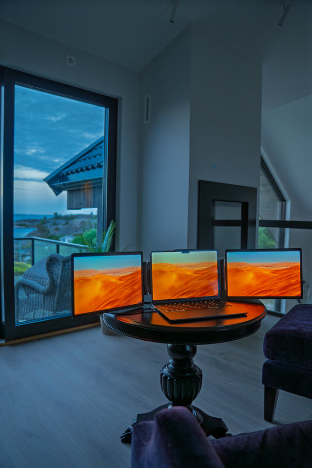 Three screens on a round table indoors